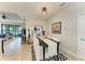 Elegant dining area featuring a black table with white chairs and a view of the outdoor living space at 4625 Canoe Creek Ave, Parrish, FL 34219