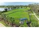 Large, fenced dog park features lush green space and a shaded seating area at 4625 Canoe Creek Ave, Parrish, FL 34219