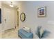 Bright entryway featuring a tile floor, hall tree, decorative clock, and stylish accents at 4625 Canoe Creek Ave, Parrish, FL 34219