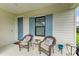 Cozy front porch featuring seating and stylish blue shutters for a welcoming entrance at 4625 Canoe Creek Ave, Parrish, FL 34219