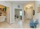 Inviting hallway featuring neutral tones, tile flooring, and access to a laundry room and office space at 4625 Canoe Creek Ave, Parrish, FL 34219