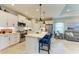 Bright kitchen showcasing white cabinets, stainless steel appliances, and an island with stylish seating at 4625 Canoe Creek Ave, Parrish, FL 34219