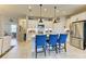 Open kitchen featuring white cabinets, stainless steel appliances, and a large island with seating at 4625 Canoe Creek Ave, Parrish, FL 34219