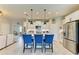 Modern kitchen featuring white cabinets, stainless steel appliances, and an island with bar stools at 4625 Canoe Creek Ave, Parrish, FL 34219