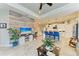 Living room showcases a seamless transition to a modern kitchen and dining space, bathed in natural light at 4625 Canoe Creek Ave, Parrish, FL 34219