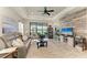 Spacious living room featuring a large window with water view, comfortable seating, and stylish decor at 4625 Canoe Creek Ave, Parrish, FL 34219
