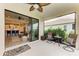 Relaxing covered patio boasts a ceiling fan and a smooth transition to an open-concept layout with views of kitchen and living area at 4625 Canoe Creek Ave, Parrish, FL 34219