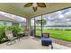 Enjoy the serene screened patio with calming water views, palm trees, and comfortable seating for relaxing and entertaining guests at 4625 Canoe Creek Ave, Parrish, FL 34219