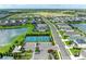 Aerial view of pristine tennis courts in a well-maintained community with lush landscaping and scenic ponds at 4625 Canoe Creek Ave, Parrish, FL 34219