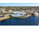 Aerial view of community pool and clubhouse with lush landscaping and serene lake at 4802 51St W St # 808, Bradenton, FL 34210