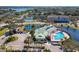 Aerial view of community amenities with pool, tennis courts, and serene lake views at 4802 51St W St # 808, Bradenton, FL 34210