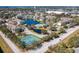 Aerial view of condo community with lake, pool, tennis courts, lush landscaping and surrounding neighborhood at 4802 51St W St # 808, Bradenton, FL 34210