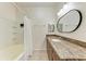 Bright bathroom featuring a granite vanity top and a bathtub with shower at 4802 51St W St # 808, Bradenton, FL 34210