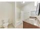Bathroom with granite vanity, white tub, and white ceramic toilet at 4802 51St W St # 808, Bradenton, FL 34210