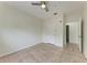 A bedroom with tile floors, ceiling fan, and ensuite bathroom at 4802 51St W St # 808, Bradenton, FL 34210