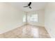 Bedroom with neutral walls, tile flooring, ceiling fan, and two windows at 4802 51St W St # 808, Bradenton, FL 34210