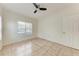 This is a bedroom with tile flooring, window, and ceiling fan at 4802 51St W St # 808, Bradenton, FL 34210