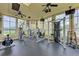Well-equipped community gym with multiple exercise machines, ceiling fans, and wall-mounted TV at 4802 51St W St # 808, Bradenton, FL 34210