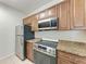 Updated kitchen showcases stainless steel appliances and granite countertops at 4802 51St W St # 808, Bradenton, FL 34210