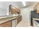 Kitchen featuring granite countertops, stainless steel appliances, and wood cabinetry at 4802 51St W St # 808, Bradenton, FL 34210