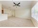 Bright living room with ceiling fan, large window, and neutral tile flooring at 4802 51St W St # 808, Bradenton, FL 34210