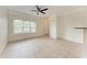 Open living room with neutral tile flooring and a view of the front entry at 4802 51St W St # 808, Bradenton, FL 34210