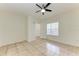 Light-filled room with tile flooring, ceiling fan and an open door with natural lighting at 4802 51St W St # 808, Bradenton, FL 34210