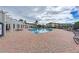 Relaxing community pool area with lounge chairs and pergola at 4802 51St W St # 808, Bradenton, FL 34210