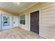Inviting covered porch featuring a tiled floor and two entry doors at 4802 51St W St # 808, Bradenton, FL 34210
