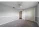 Gray bedroom featuring carpet flooring, ceiling fan, and closet with doors at 496 Fletcher St, Port Charlotte, FL 33954