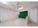 Bright bonus room features two doors, tile flooring, and a faux greenery wall at 496 Fletcher St, Port Charlotte, FL 33954