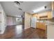 Bright kitchen with light wood cabinets, contrasting dark hardwood floors, and modern appliances offers a stylish cooking space at 496 Fletcher St, Port Charlotte, FL 33954