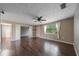 Spacious living room featuring large windows, hardwood floors, and an open layout ideal for gatherings and relaxation at 496 Fletcher St, Port Charlotte, FL 33954