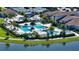 Aerial view highlighting the community pool, palm trees, cabanas, and well-maintained landscaping within a gated neighborhood at 5187 Barnett Cir, Lakewood Ranch, FL 34211