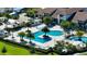Stunning aerial view of the community's resort-style pool, cabanas, lush landscaping, and beautifully designed clubhouse at 5187 Barnett Cir, Lakewood Ranch, FL 34211