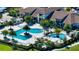 Stunning aerial view showcasing resort-style pool area surrounded by palm trees and luxurious lounging spaces at 5187 Barnett Cir, Lakewood Ranch, FL 34211