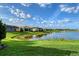 Expansive backyard overlooks a peaceful lake, offering a serene view and ample green space at 5187 Barnett Cir, Lakewood Ranch, FL 34211