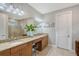 Bathroom with double sink vanity, stone countertop, large mirror, and a tiled walk-in shower at 5187 Barnett Cir, Lakewood Ranch, FL 34211