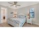Charming bedroom with a queen bed, a coastal theme, a ceiling fan, and an abundance of natural light at 5187 Barnett Cir, Bradenton, FL 34211