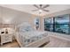 Bright bedroom featuring a ceiling fan, large windows and two nightstands with lamps at 5187 Barnett Cir, Lakewood Ranch, FL 34211