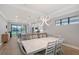 Open concept dining and kitchen area featuring a modern light fixture and neutral paint at 5187 Barnett Cir, Bradenton, FL 34211