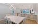 Bright dining area featuring a contemporary chandelier and an open view into the kitchen at 5187 Barnett Cir, Lakewood Ranch, FL 34211