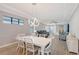 Modern dining room with pendant lighting and open floor plan to living area at 5187 Barnett Cir, Lakewood Ranch, FL 34211