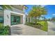 Stunning clubhouse entrance showcasing the manicured landscaping and architectural details under a bright blue sky at 5187 Barnett Cir, Lakewood Ranch, FL 34211