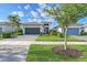 Beautiful single-Gathering home featuring a well-maintained lawn, paver driveway, and lush landscaping at 5187 Barnett Cir, Lakewood Ranch, FL 34211