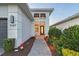 Inviting home entrance with a brick walkway, a decorative gnome, and vibrant landscaping at 5187 Barnett Cir, Bradenton, FL 34211