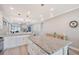 Bright kitchen featuring white cabinets, granite countertops and a large center island with bar stool seating at 5187 Barnett Cir, Lakewood Ranch, FL 34211