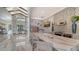 Open kitchen and gathering space with stainless appliances and a large marble island and floors at 5187 Barnett Cir, Lakewood Ranch, FL 34211