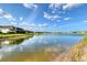 Scenic lake view showcasing the water, fountain, community landscaping, and clear blue sky reflecting on the surface at 5187 Barnett Cir, Lakewood Ranch, FL 34211