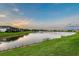Beautiful lake view at sunset with lush green landscaping and tranquil water features at 5187 Barnett Cir, Lakewood Ranch, FL 34211